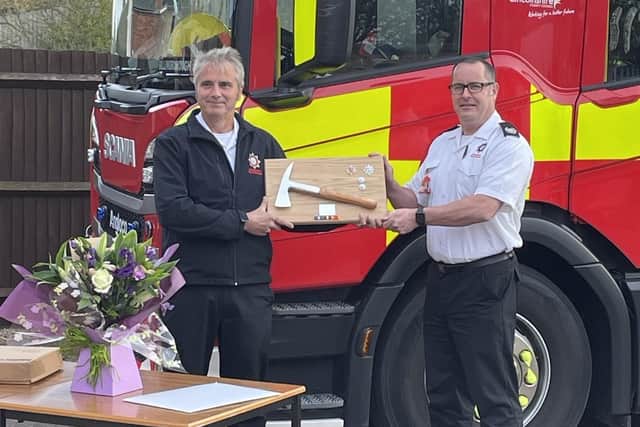 Watch manger Gary Bellamy receives his commemorative axe from group manager Matt Perrin.