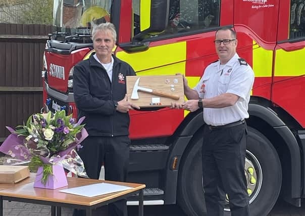 Watch manger Gary Bellamy receives his commemorative axe from group manager Matt Perrin.