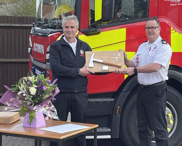 Watch manger Gary Bellamy receives his commemorative axe from group manager Matt Perrin.