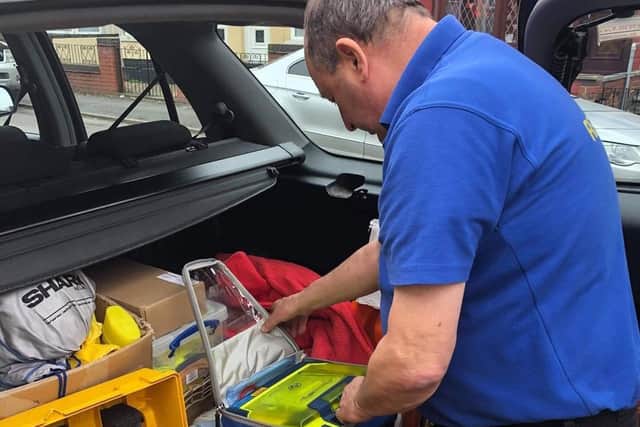 L-CAT Community First Responder, Pat Gilding, checking his defibrillator for call outs with East Midlands Ambulance Service.