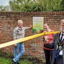 Coun Stephen Bunney cuts the ribbon to officially open the kitchen garden, watched by Cathy Sirrett, left, and Nicky Brooksbank EMN-210518-102144001