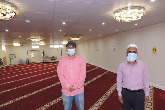 Nadim Aziz (right) shows of the men's prayer room downstairs. EMN-211205-161549001