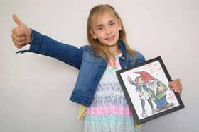 Darcy with the cartoon of herself with a gnome that was delivered at the dead of night.