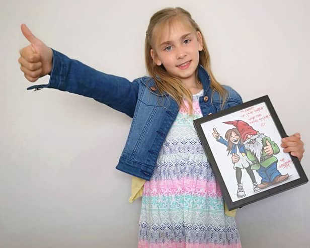 Darcy with the cartoon of herself with a gnome that was delivered at the dead of night.