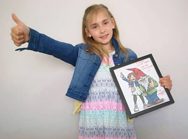 Darcy with the cartoon of herself with a gnome that was delivered at the dead of night.