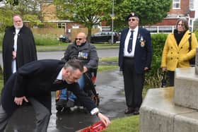 Tony Kelly, committee member of the Royal British Legion in Skegness, lays a wreath at the memorial at St Matthew's Church.