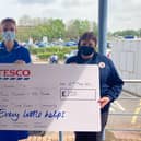 Tesco's Rachael Bell hands the cheque to Sister Judith Green