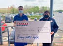 Tesco's Rachael Bell hands the cheque to Sister Judith Green