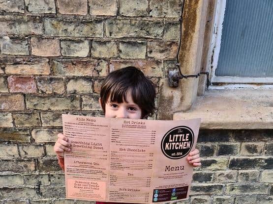 Luca Cunningham checks out the menu at The Little Kitchen