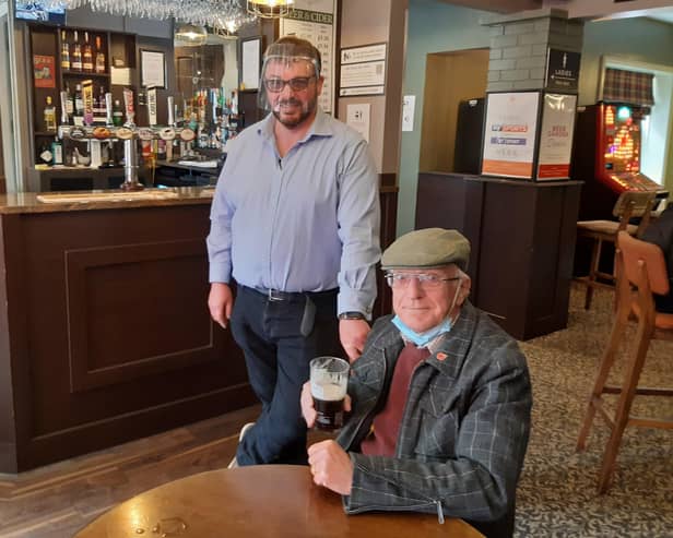 Cheers! White Swan landlord Martin Scoot with Les Tranter EMN-210518-104501001