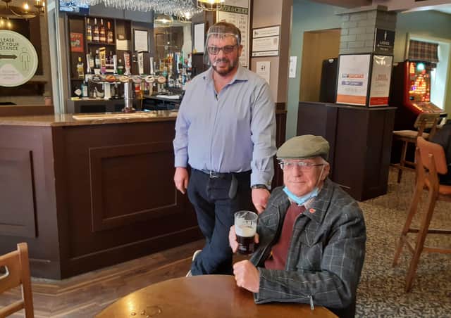 Cheers! White Swan landlord Martin Scoot with Les Tranter EMN-210518-104501001