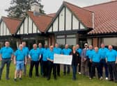 The 9-ers hand over the cheque.
