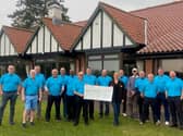 The 9-ers hand over the cheque.