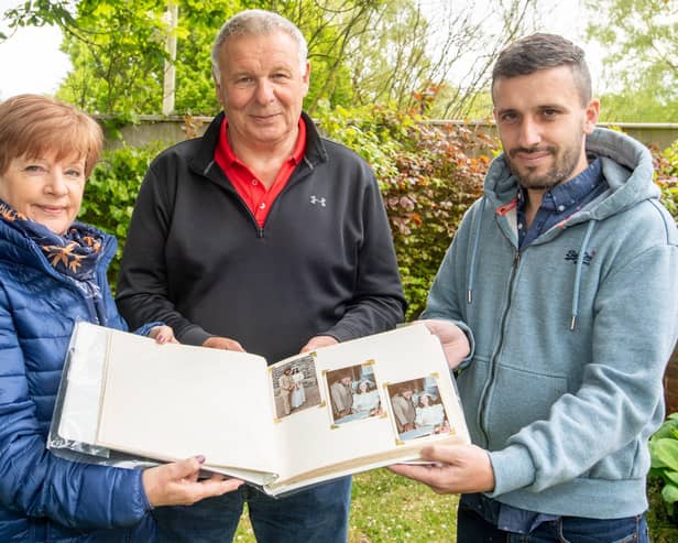 Joanne Markham and Adrian 'Smiler' Hutson look through the album. (Photo: John Aron)