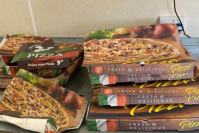 Pizza boxes found in blue bin