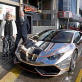 Mayor and Mayoress of Skegness Coun Trevor and Jane Burnham stand by the Lamborghini befire it is hoisted into the new Supercar VIP Lounge in Skegness.