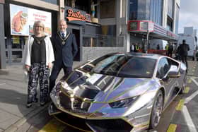 Mayor and Mayoress of Skegness Coun Trevor and Jane Burnham stand by the Lamborghini befire it is hoisted into the new Supercar VIP Lounge in Skegness.