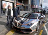 Mayor and Mayoress of Skegness Coun Trevor and Jane Burnham stand by the Lamborghini befire it is hoisted into the new Supercar VIP Lounge in Skegness.