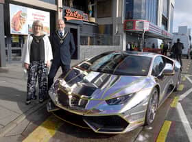 Mayor and Mayoress of Skegness Coun Trevor and Jane Burnham stand by the Lamborghini befire it is hoisted into the new Supercar VIP Lounge in Skegness.