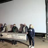Members of the Caistor Community Cinema team in front of the mega screen