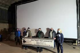 Members of the Caistor Community Cinema team in front of the mega screen