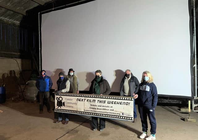 Members of the Caistor Community Cinema team in front of the mega screen