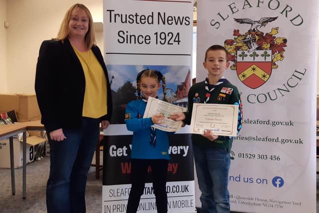 Samantha Smith of Grunwald UK presents the Young Community Volunteer Award to Tobias and Arabella Shaw. EMN-210528-155420001