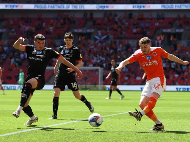 Blackpool's Elliot Embleton shoots whilst under pressure from Max Sanders. (Photo by Catherine Ivill/Getty Images)