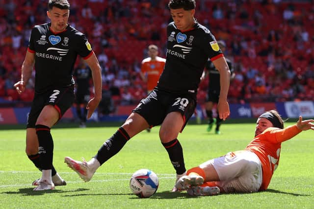 Luke Garbutt of Blackpool stretches for the ball whilst under pressure from Brennan Johnson. (Photo by Catherine Ivill/Getty Images)