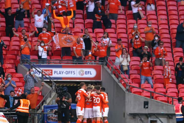 The Blackpool players and fans celebrate. (Photo by Catherine Ivill/Getty Images)