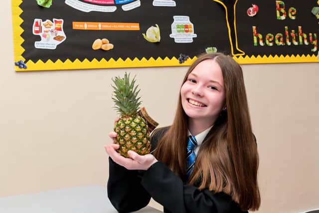 Year 9 student Jess Hopps samples some of the delicious fruit available as part of Louth Academy’s efforts towards all-round wellbeing