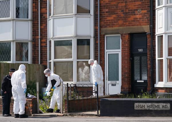 Police officers at the scene in High Holme Road, Louth, following the death of a woman and child on Monday. Picture: PA Wire.