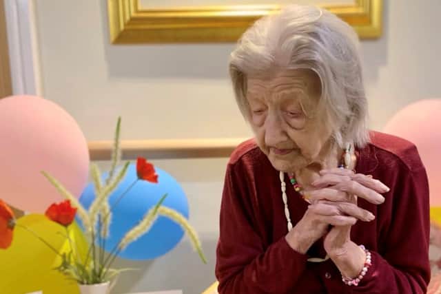 Gladys Ranshaw pictured with birthday cards, balloons and a birthday cake EMN-210206-104630001