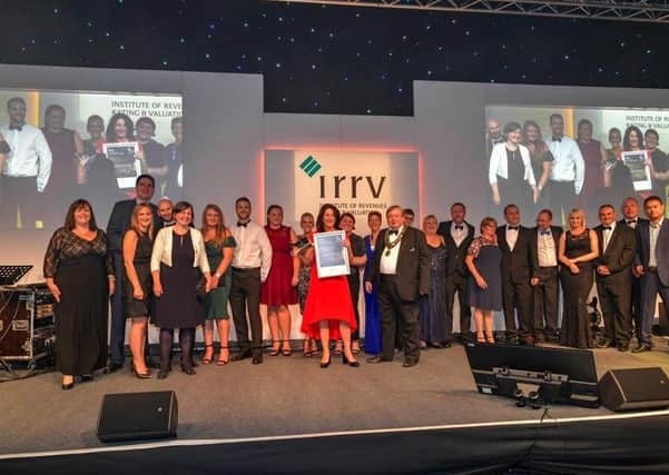 The revenues and benefits team receiving their award in 2018.