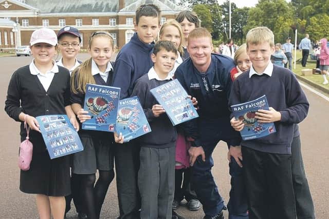 Cranwell Primary School pupils try to get an autograph from a member of the RAF parachute display team.