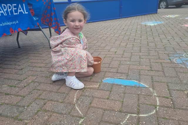 Masi Andrews, 5, of Tamworth, Birmingham, colouring in a poppy.