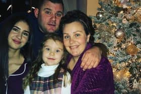 Carly (right) with her partner, Adam, and daughters Farrah, 5, and Chloe, 19.