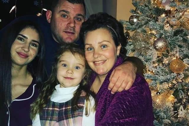 Carly (right) with her partner, Adam, and daughters Farrah, 5, and Chloe, 19.