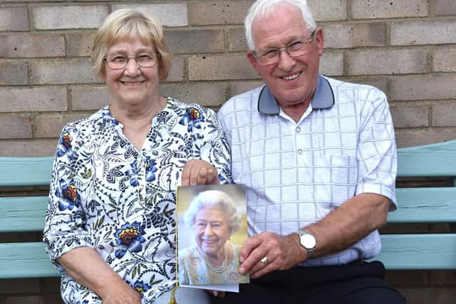 Betty and Geoff Ward with their card from The Queen.
Photo by John Edwards
