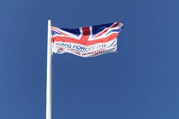 The Armed Forces Day flag, hoisted last year.. EMN-210614-181338001