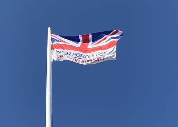 The Armed Forces Day flag, hoisted last year.. EMN-210614-181338001