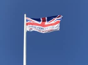 The Armed Forces Day flag, hoisted last year.. EMN-210614-181338001