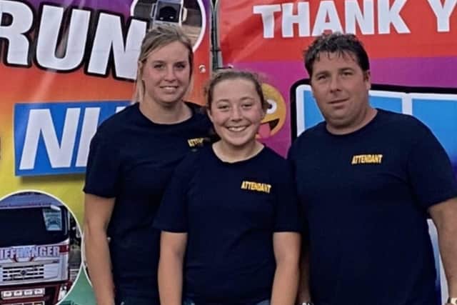 George Rowland Tucker, Tyla Tucker and Kristina Cole at the entrance to the fun fair.