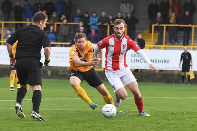 Shane Byrne battles with former Boston United midfielder Jamie McGuire. Photo: David Dawson