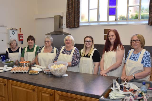 Norma Higton BEM is poctured centre, with those  who helped with the meals during the pandemic, from left, Judy Dixon, Jane Warner, Fiona Blackburn,  Alisha Blackburn, Alison Annis and Kath Edmondson. Photo by John Edwards