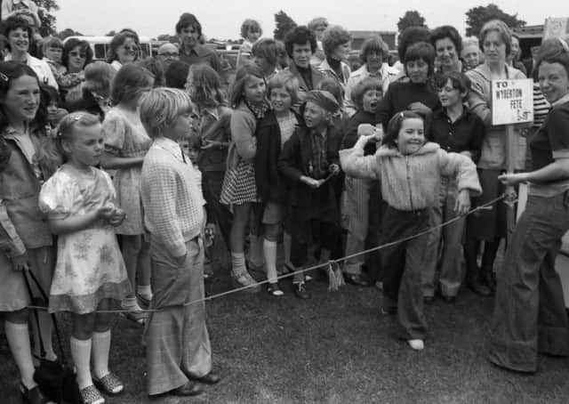 A youngster gets set to release a wet sponge at Wyberton Primary School's summer fete 45 years ago.