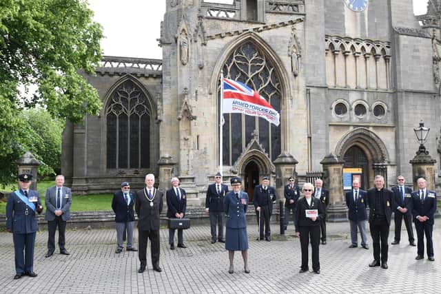 Council and military representatives attended a small flag raising ceremony for Armed Forces Day on Monday in Sleaford market place. Photo: NKDC EMN-210621-151126001