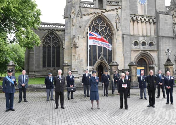 Council and military representatives attended a small flag raising ceremony for Armed Forces Day on Monday in Sleaford market place. Photo: NKDC EMN-210621-151126001