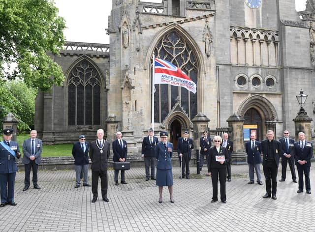 Council and military representatives attended a small flag raising ceremony for Armed Forces Day on Monday in Sleaford market place. Photo: NKDC EMN-210621-151126001