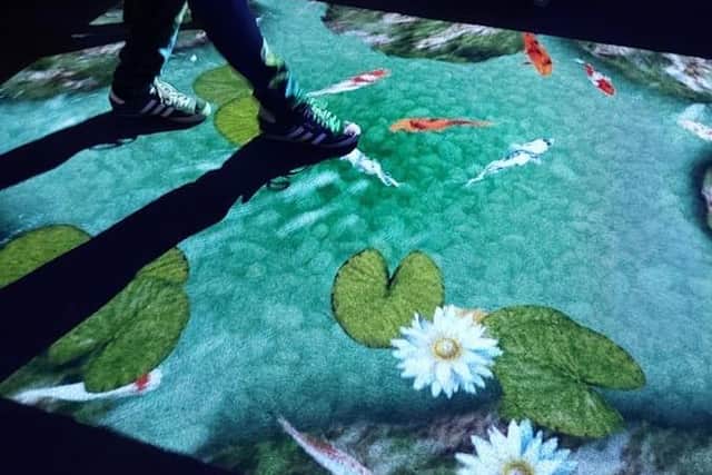 Trying out the interactive floor in the sensory room. EMN-210621-140817001